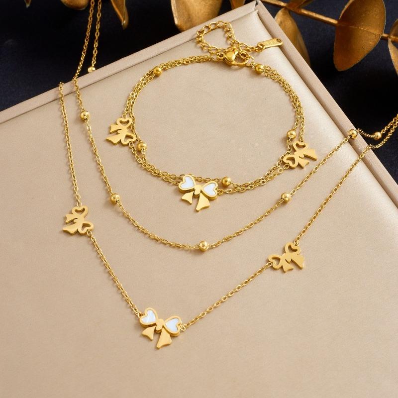 Gold Bow Charm Jewelry Set: Necklace and Bracelet with White Enamel Accents
