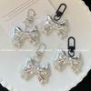 High-Grade Silver Bow Keychain: Metal Door Buckle Pendant for Bags & Phones