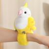 Cute parrot plush wristband with snap closure. Colorful bird-shaped wearable toy for kids, lovely collectible accessory.