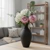A decorative vase in the shape of a jug, black, for flowers, elegant design.