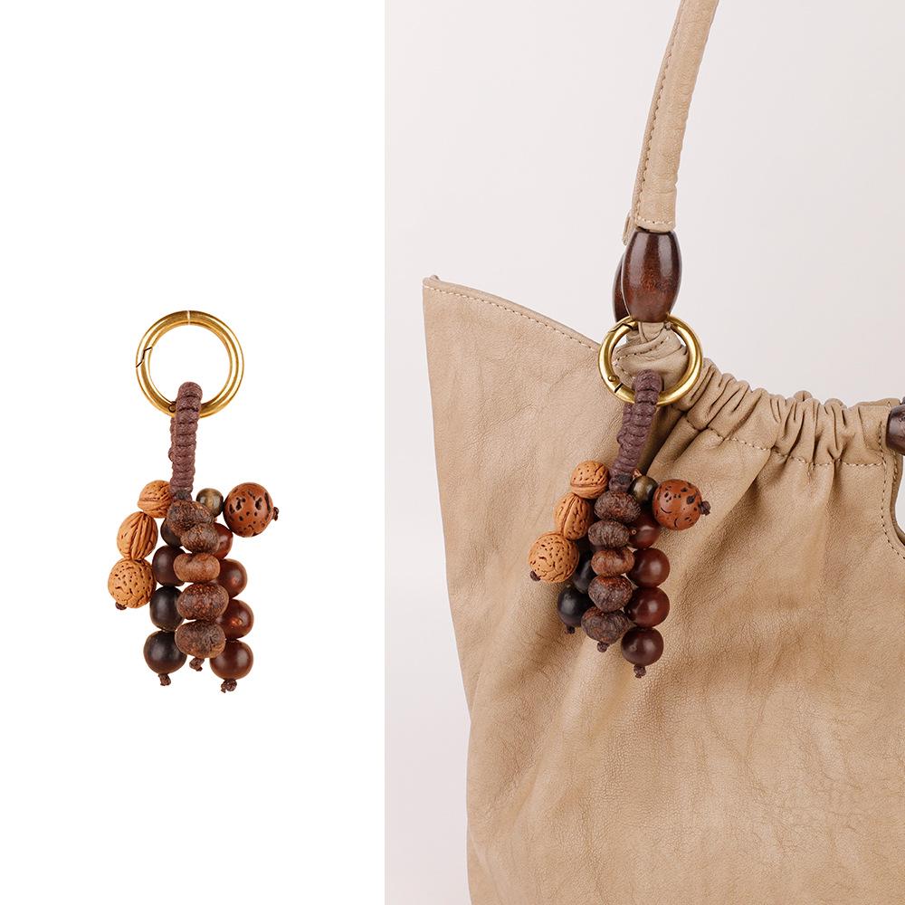 Wish-Fulfilling Bodhi Seed String Bag Charm - Hand-Woven Natural Keychain Ornament with Turquoise.