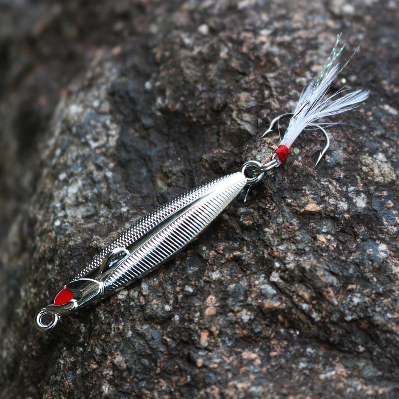Серебристая металлическая приманка (маленькая рыбка, мормышка) с тройным крючком и пером
