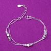 "Silver Double-Layer Anklet with Beads and Star Charm - Japanese & Korean Summer Fashion for Girls."