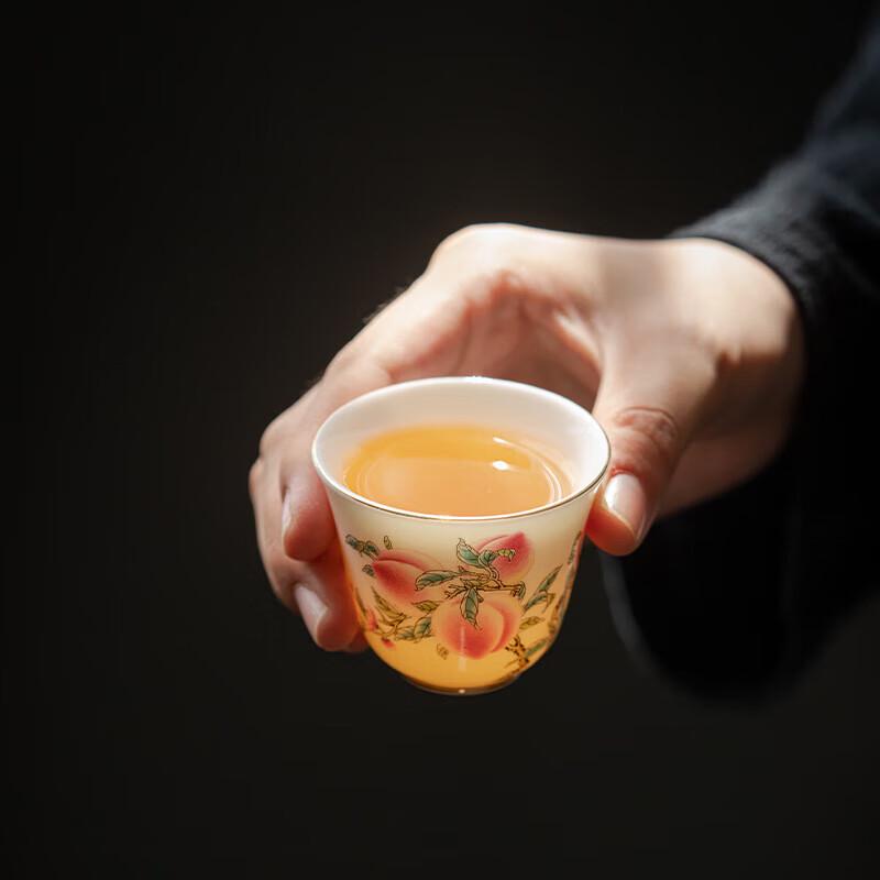Dehua Suet Jade White Porcelain Teacup with Nine Peaches Design