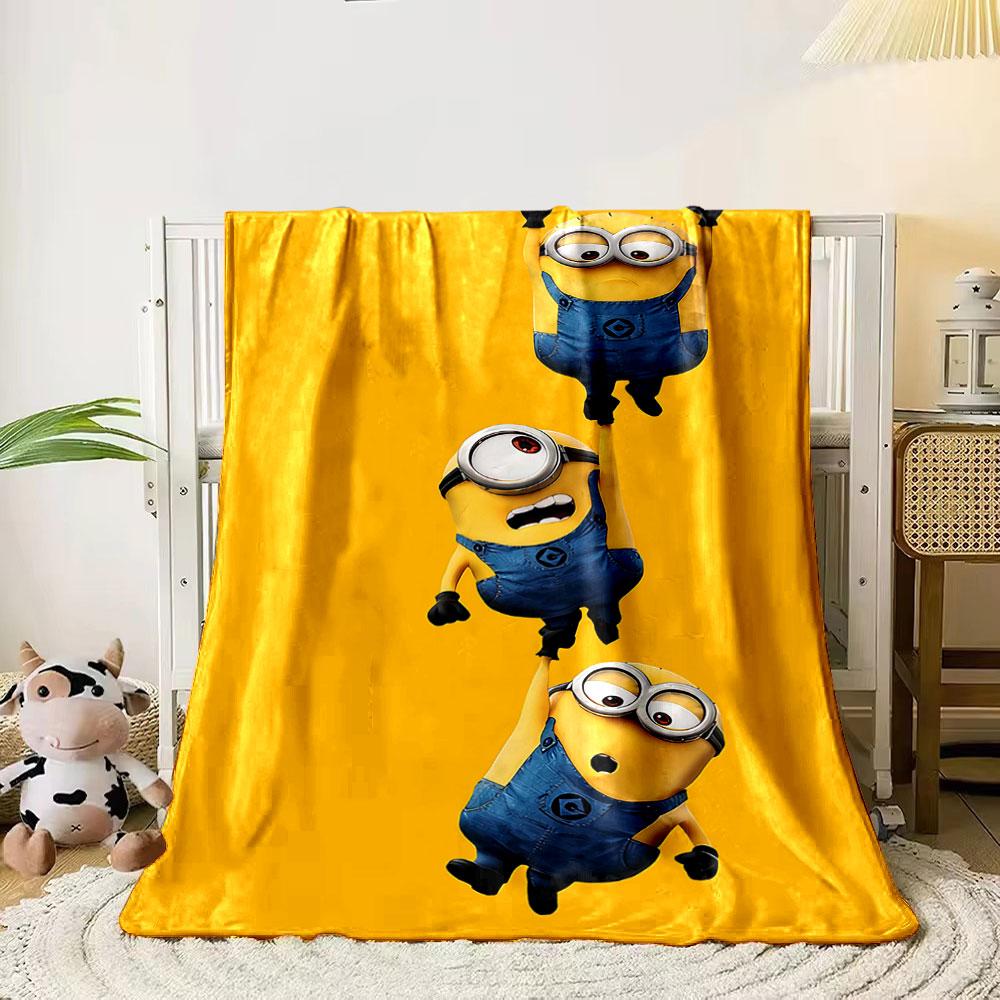 Three Minions in blue overalls hanging from each other on a yellow background. for all seasons blanket lunch break throw gift