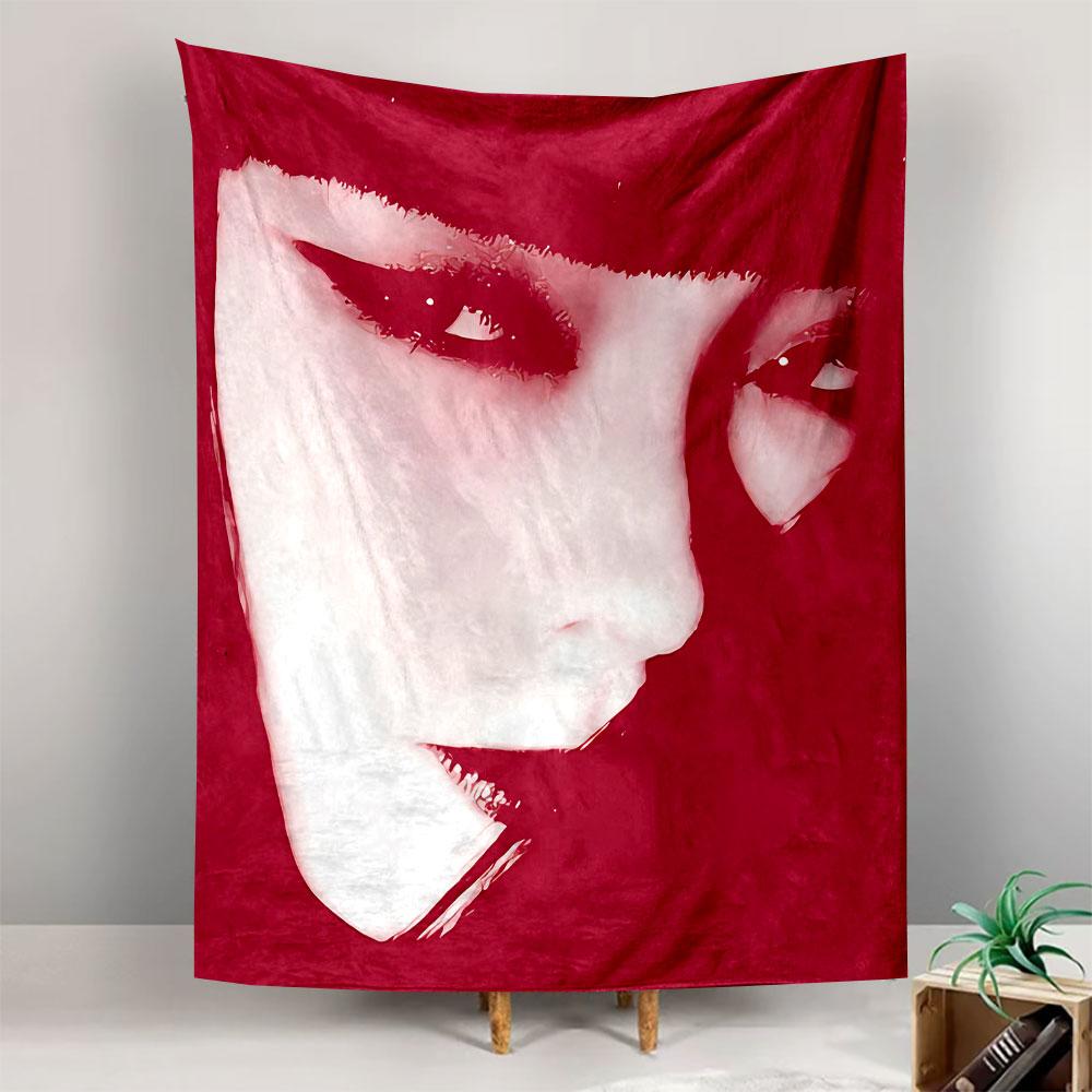 High-contrast close-up of a face with bold eyeliner and red tones. Patterned tapestry for bedroom and living room home decor