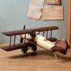 Vintage metal plane crafts and a retro biplane aircraft model desktop decoration photo prop.