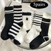 5 pairs of fashionable black and white mid tube socks, unisex, with black and white striped design