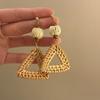 Raffia straw exaggerated earrings Bohemian style sunflower motif beach vacation vibe simple yet sophisticated look.