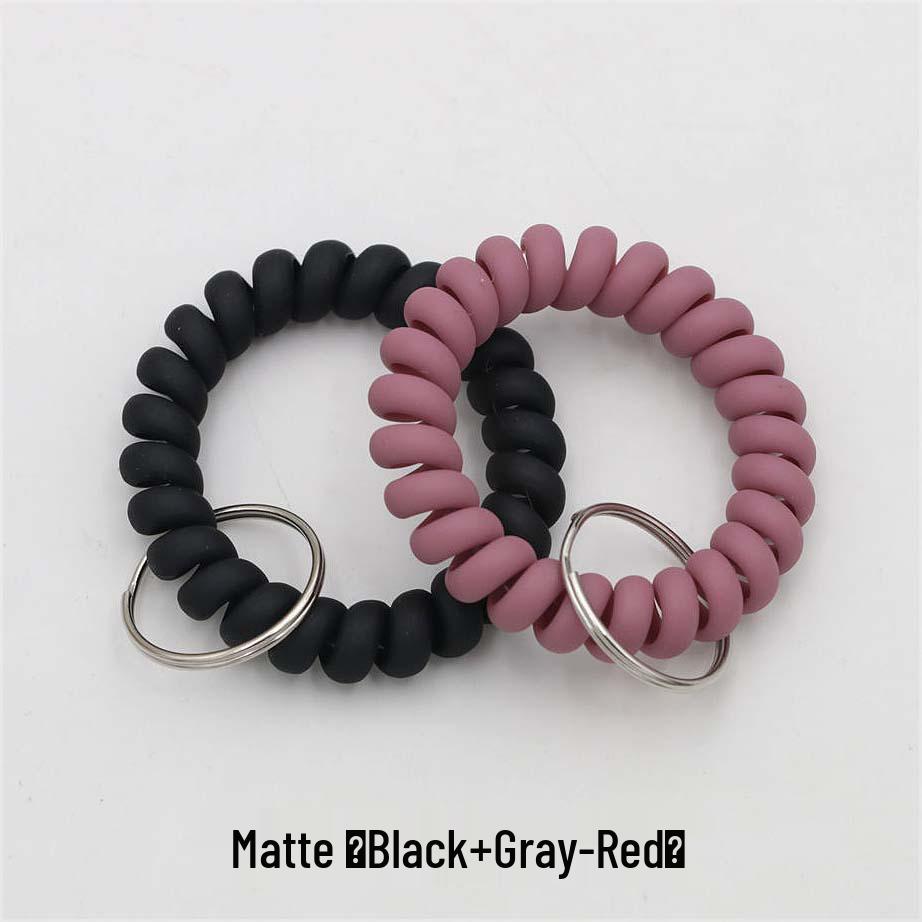 Минималистичный браслет-брелок и резинка для волос в виде пружинного механизма