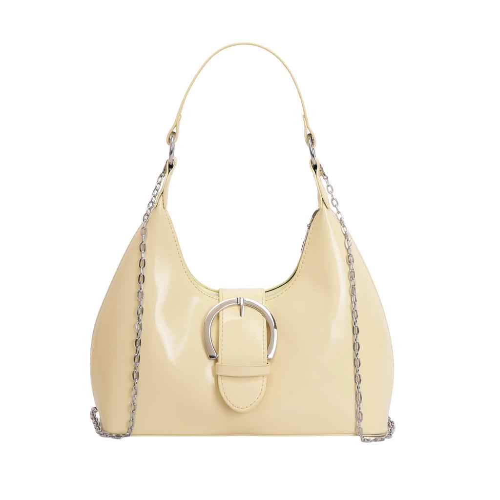 Solid color crescent-shaped hobo bag with metal D-ring embellishment, elegant underarm bag, versatile women's handbag for dates and everyday wear.