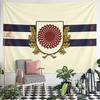 A shield with a red sunburst, flanked by golden oak leaves and blue stripes. Patterned tapestry for bedroom and living room home decor
