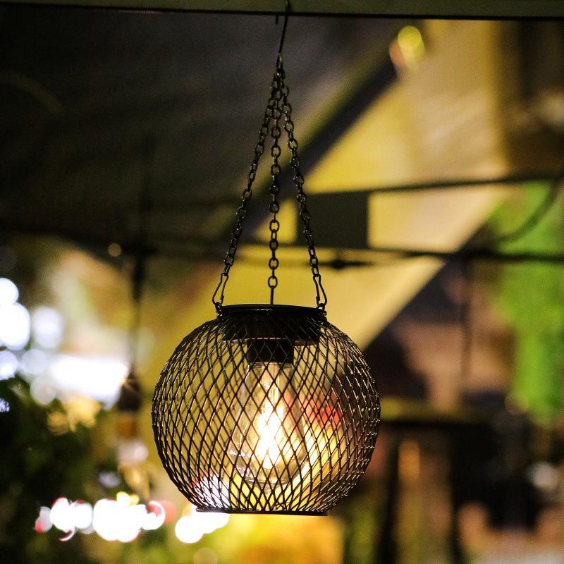 Solar Wrought Iron Lantern Light: Retro Mesh Pendant for Outdoor Garden, Courtyard, and Balcony Ambiance.