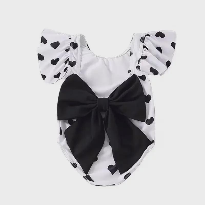 2024 Korean Girl's One-Piece Swimsuit: Black & White Heart with Bow and Lotus Leaf Sleeves.