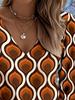The new women's blouse features a printed V-neck long-sleeve design. It adopts Bohemian-style fringed sleeves and is perfect for spring.