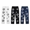 EastRogue High Street Hip Hop Streetwear Loose Fit Men's and Women's Denim Jeans with Washed Effect and Full Print of Hibiscus Flowers.