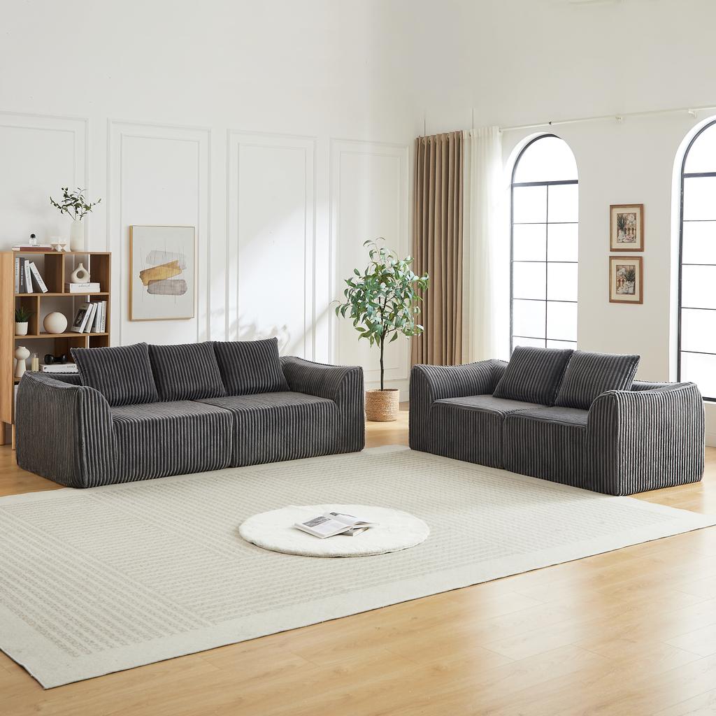 Minimalist corduroy sofa with slim lines, a gently sloping backrest, and five cushions.