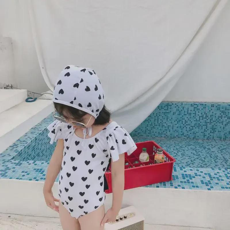 2024 Korean Girl's One-Piece Swimsuit: Black & White Heart with Bow and Lotus Leaf Sleeves.