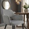 Gray velvet chair with Scandinavian quilting and black legs for the living room