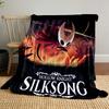 A masked figure wields a needle, set against a fiery, intense background. for all seasons blanket lunch break throw gift