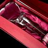 A tall heart-shaped crystal award statuette on a column as a gift with a decorative gift box