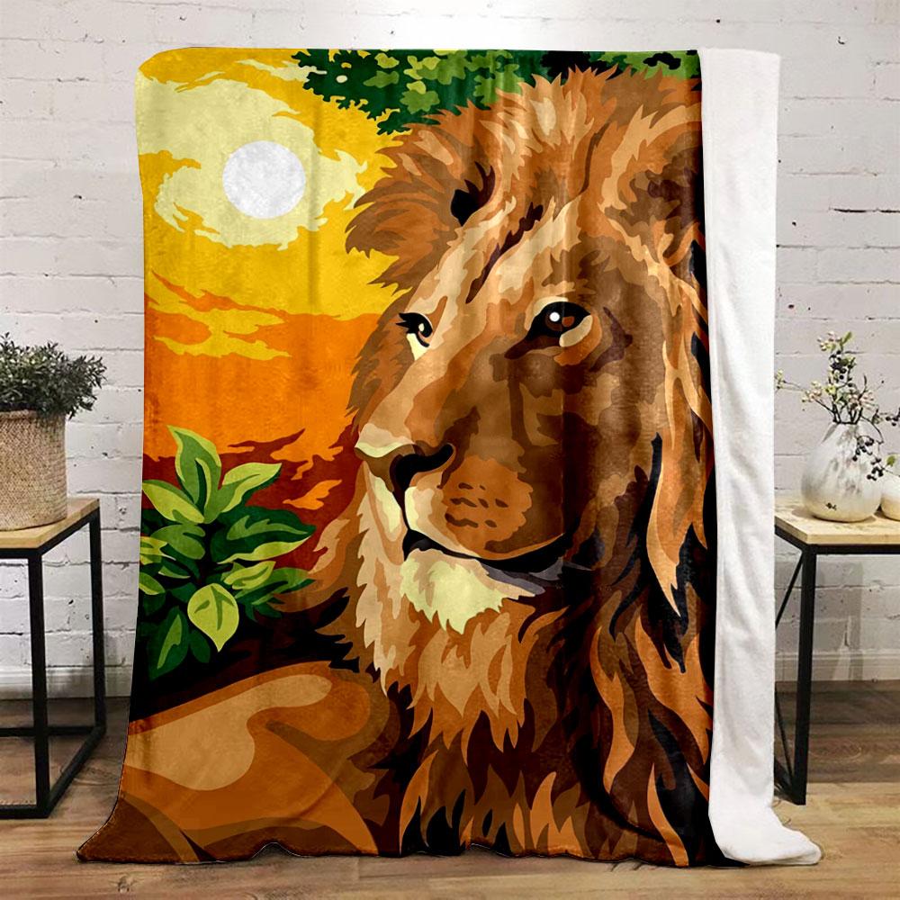 A majestic lion with a vibrant orange sunset and green foliage background. for all seasons blanket lunch break throw gift