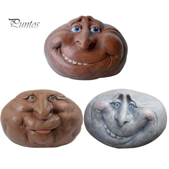 Небольшие садовые скульптуры в виде улыбающегося камня