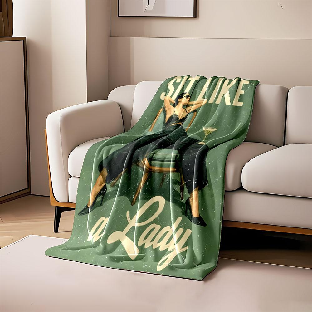 A woman confidently lounging in a chair with bold text in the background. for all seasons blanket lunch break throw gift