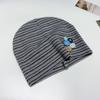 Autumn and winter new retro button striped cold hat sweet cool wind niche design sense high elastic knitted hat