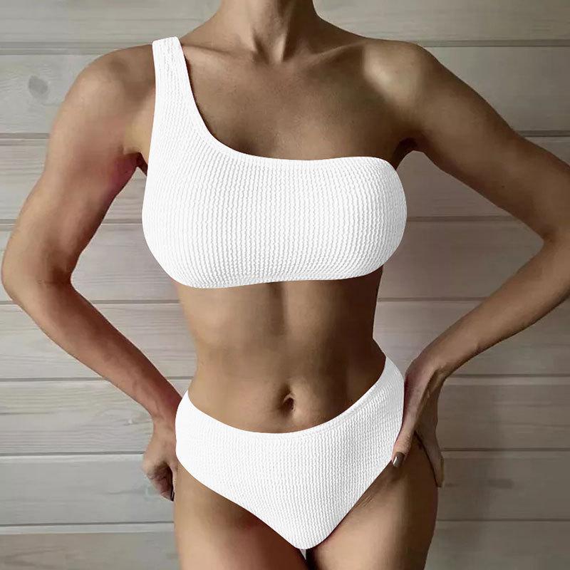 Igo new European and American bikini sexy solid color split wave cloth shoulder swimsuit women's bikini swimsuit
