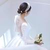 Elegant Satin Long-Sleeve Wedding Dress with Train and Arm Coverage.