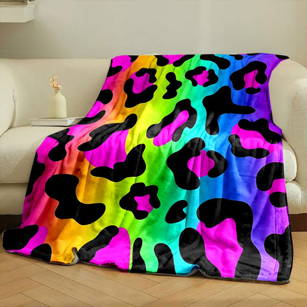 Leopard-like spots with black shapes on a vibrant rainbow gradient background. for all seasons blanket lunch break throw gift