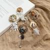 Retro Rattan Tassel Flower Bow Brooch: Elegant Autumn-Winter Fashion Pin.