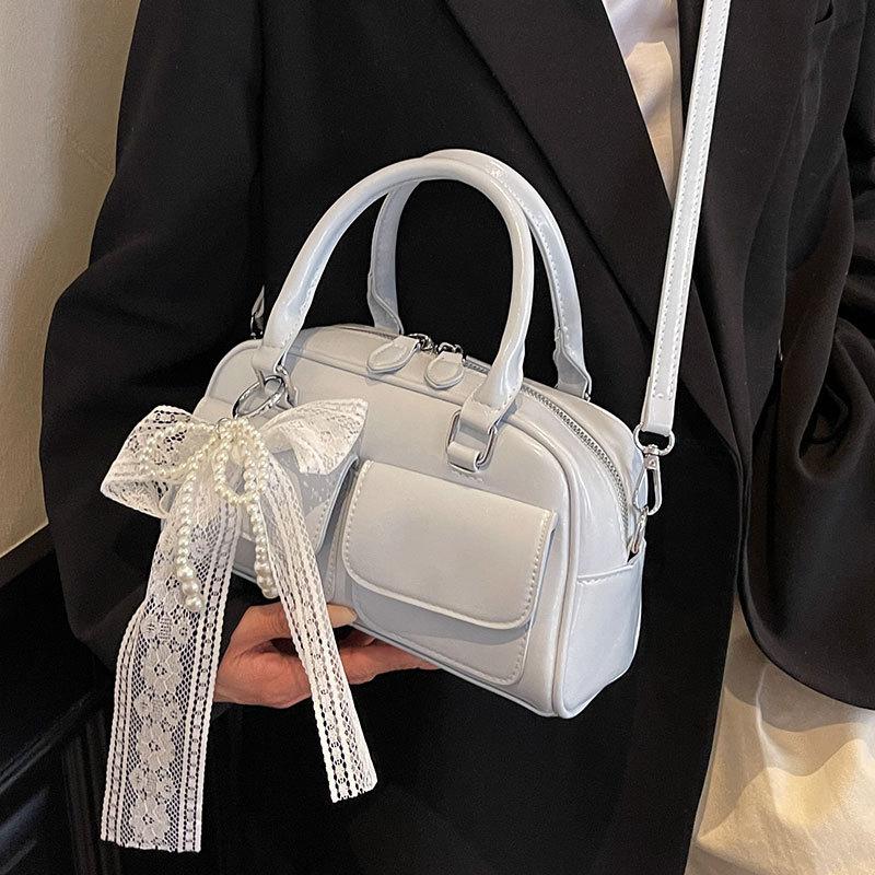 Корейская версия популярной весенне-летней дофаминовой простой портативной сумки-бостонки, нишевая повседневная сумка-мессенджер в иностранном стиле для通勤, женская