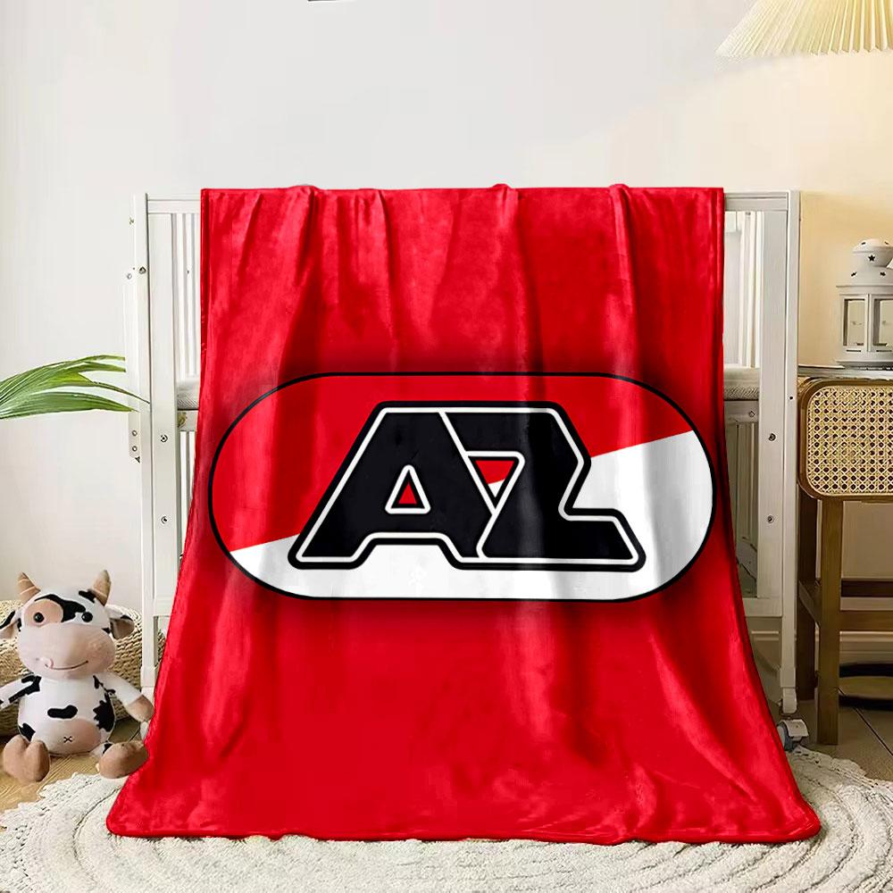 A bold "AZ" logo in black, over a red and white diagonal background. for all seasons blanket lunch break throw gift