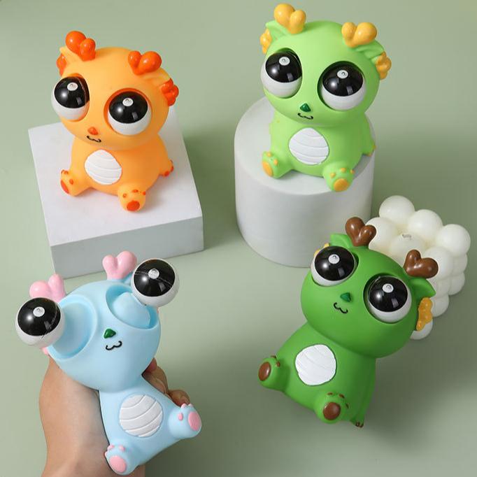 Разожмите игрушку для разминания «Взрывной глаз дракона» Сожмите куклу-дракона, чтобы выпустить игрушку «Взрывной глаз дракона»