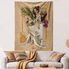 A woman in flowing white attire holds plants, surrounded by fruits and flowers. Patterned tapestry for bedroom and living room home decor