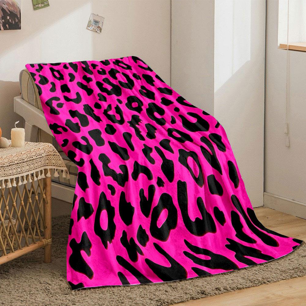 The pattern features irregular black leopard spots on a bright pink background. for all seasons blanket lunch break throw gift