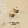 Wooden earrings made of green sandalwood, natural agarwood, and wood, with hook-shaped sandalwood pendants, in a new Chinese style