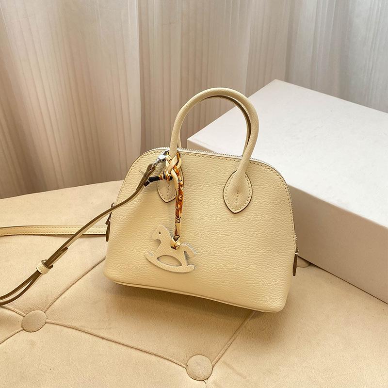 Премиальная мини-сумка-ракушка для женщин 2025 года, новая модная иностранная стильная изысканная сумка для переноски на одно плечо, диагональный пролет, воловья кожа, маленькая