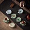 Ceramic Tea Set Coaster: Anti-Scald Round Insulation Mat with Mountain and Water Design.