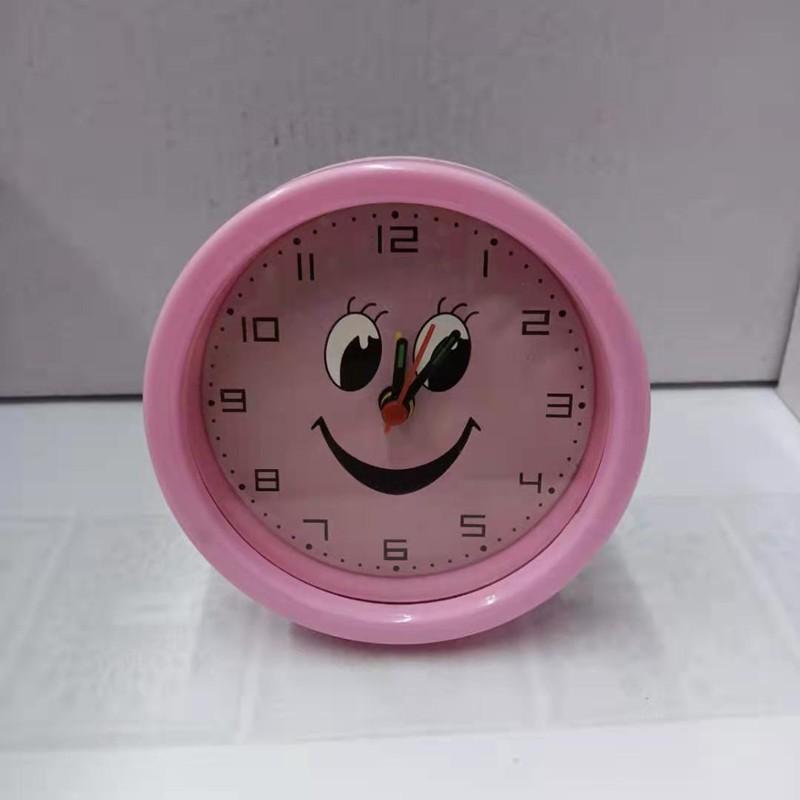 Round, Multiple Smiling Faces and Small Alarm Clock