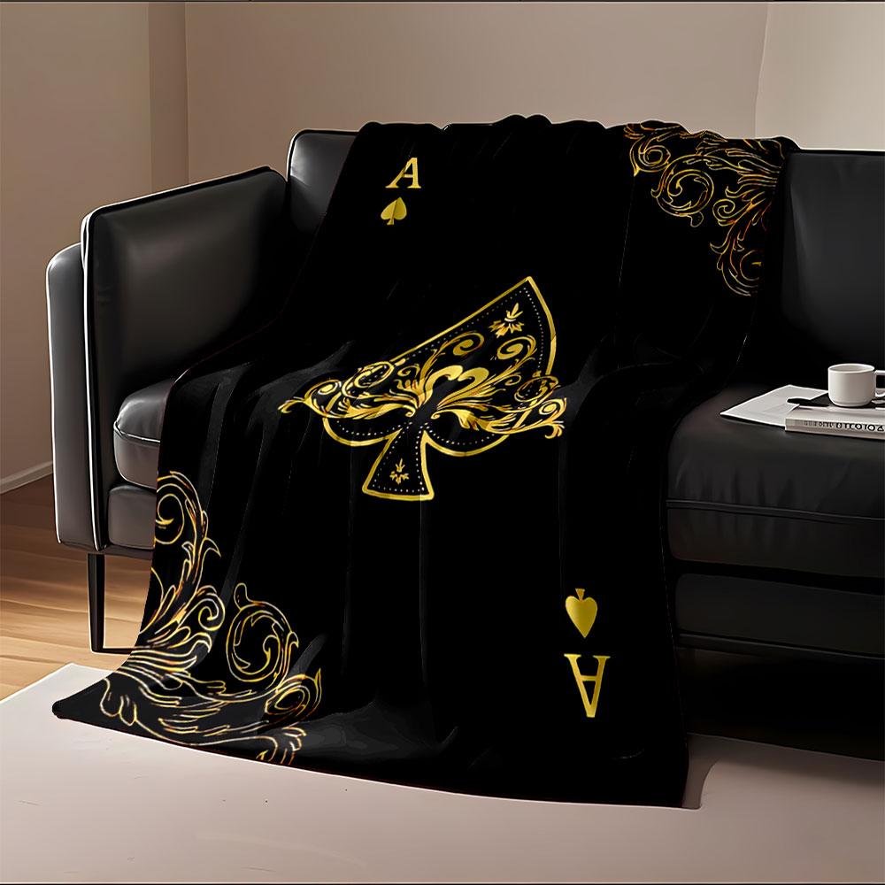 Golden ornate spade symbol with intricate swirls on a black background. for all seasons blanket lunch break throw gift