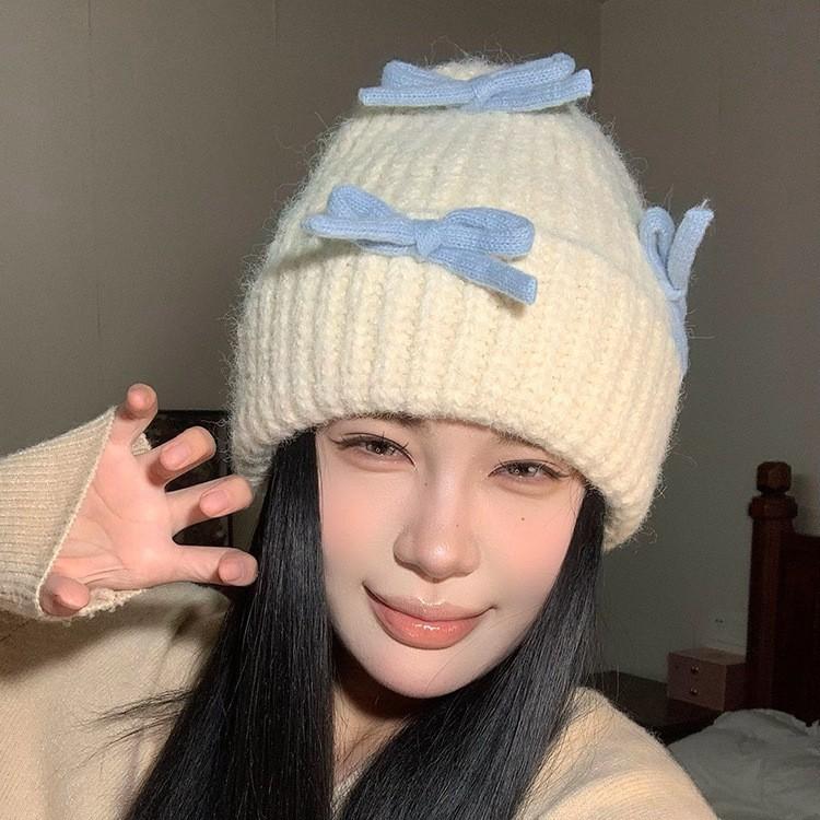 Вязаная шерстяная шапка с бантом для женщин на осень и зиму, теплая и универсальная, утолщенная защита ушей, шапка, подчеркивающая маленькое лицо