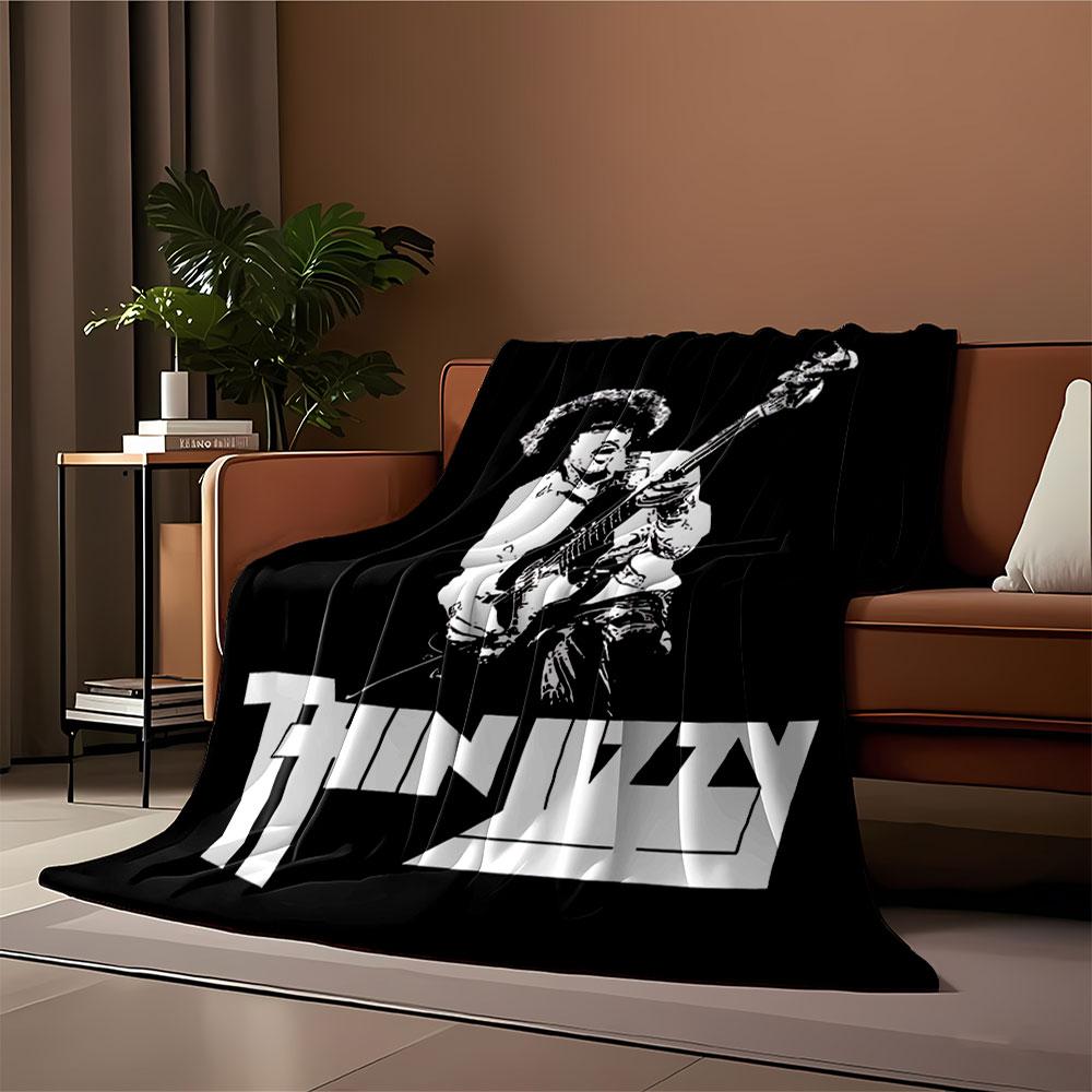 Stylized monochrome musician graphic with a bold "Thin Lizzy" logo. for all seasons blanket lunch break throw gift