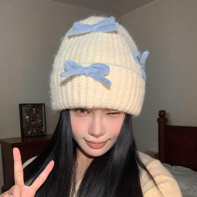 Вязаная шерстяная шапка с бантом для женщин на осень и зиму, теплая и универсальная, утолщенная защита ушей, шапка, подчеркивающая маленькое лицо