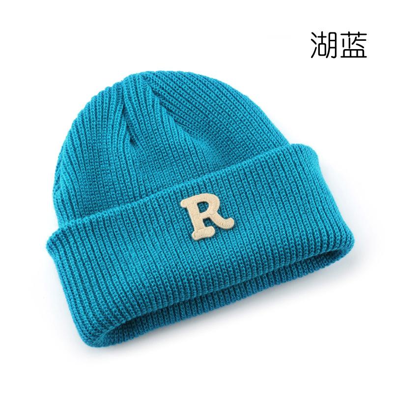 Women's Solid Color Letter Print R Rolled brim knitted hat for outdoor cycling, providing warmth, cold protection, and ear coverage