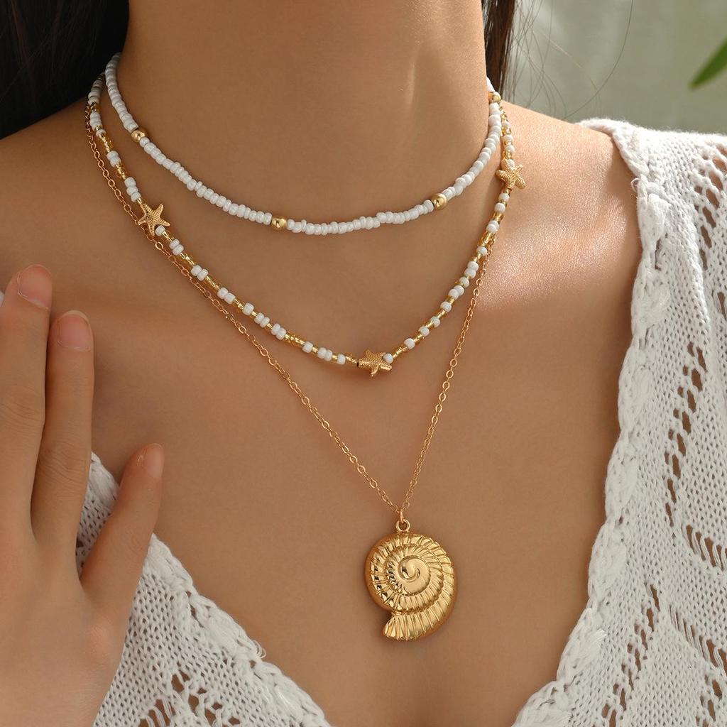 Starfish & Conch Pendant Necklace - Versatile Fashion Jewelry with Rice Bead Clavicle Chain for Women.