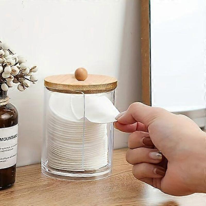 Transparent acrylic cotton ball holder with a bamboo lid for dust prevention, suitable for various spaces