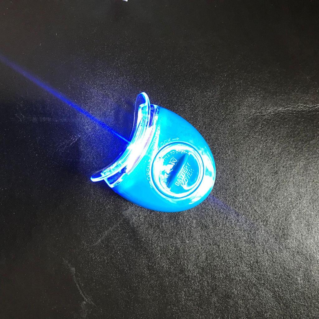 Qiao Qiang Mini Whitening Tooth Lamp: Portable Cold Light Device with Gel for Teeth Whitening, In White or Blue.
